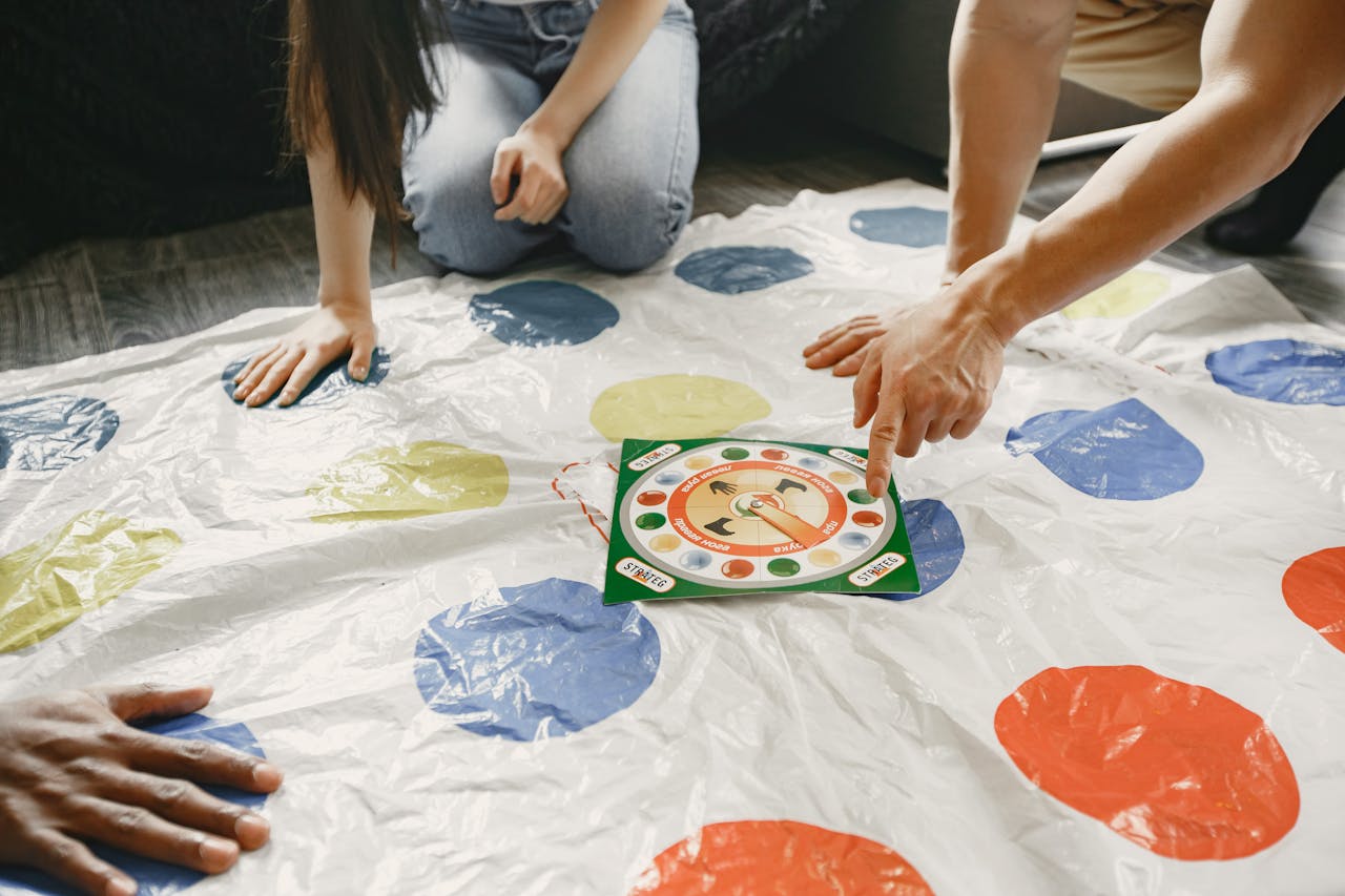 Home Hands on a colorful mat game with a spinner at the center. Fun and interactive play.